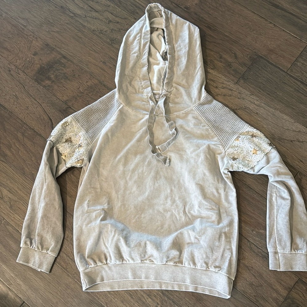 Gray hooded sweatshirt with stars in sequins on arms. Hoodie in light grey